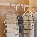 HangFive 5-tier pants hanger holding 5 pairs of pants on a closet rod